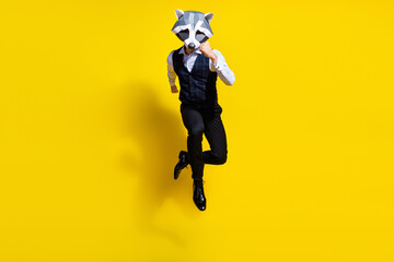 Full body photo of absurd weird guy racoon mask jump run hurry discount isolated over yellow shine...