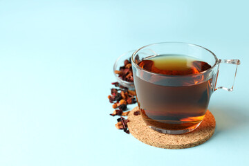 Concept of hot drink with tea on blue background
