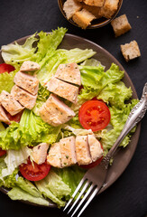 Green vegetable salad with lattuce, chicken and croutons. Healthy food concept