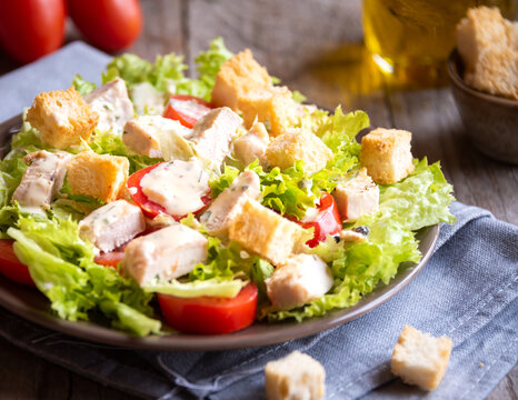 Green vegetable salad with lattuce, chicken and croutons. Healthy food concept