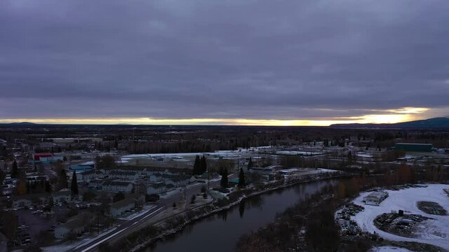 Fairbanks City and Chena River at Sunset in Winter. Alaska, USA. Aerial View. Drone Flies Forward and Upwards