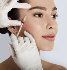 Beautiful woman receives anti wrinkle beauty injection for facial rejuvenation and wrinkle removal....