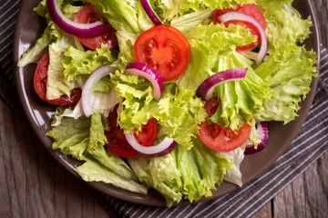 Green vegetable salad with lattuce, tomatos, onion. Healthy food concept