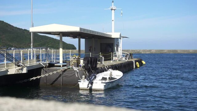 motor boat tied up to the shore of the dock near Naruto whirpools in Japan