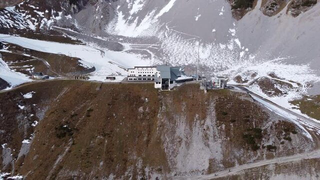 Ski Lodge And Cable Car Station At The Foot Of Nordkette Mountain In Innsbruck Austria - aerial shot