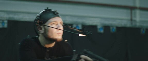 BTS Actor wearing motion capture suit acting as a game or animation movie character. Motion capture is an unparalleled method for making animated characters move more realistically