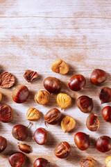 Chestnuts, shot from above on a rustic wooden background with a place for text