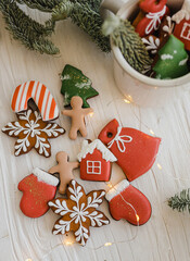 Christmas mini gingerbread cookies in a cup and on the table. New Year mood and decor. A sweet gift. Homemade cakes. A holiday card.