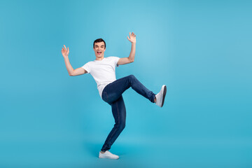 Fototapeta na wymiar Full size profile side photo of young excited man have fun playful fool isolated over blue color background