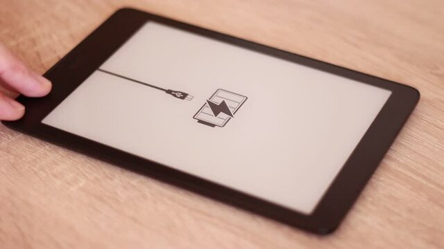 Charging Electronic tablet  on table