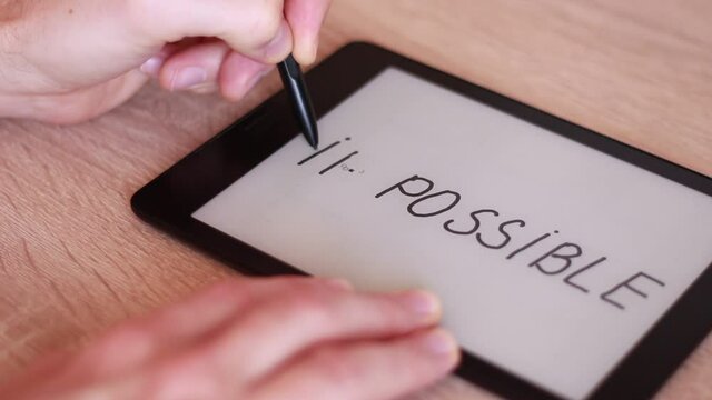 Writing IMPOSSIBLE on electronic tablet and crossing it out