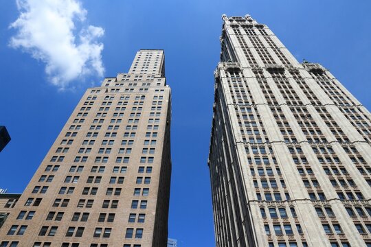 NEW YORK, USA - JULY 6, 2013: 225 Broadway and Woolworth Building (right) exterior view in New York. Woolworth Building was the tallest in the world from 1913 to 1930.