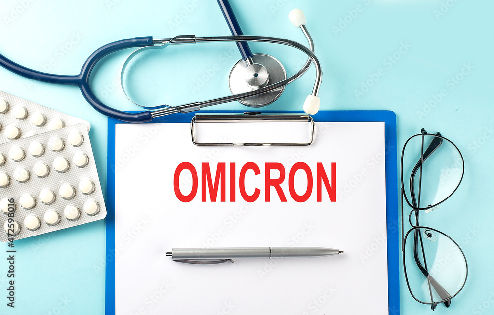 Poster paper with text omicron on a blue background with stethoscope and pills