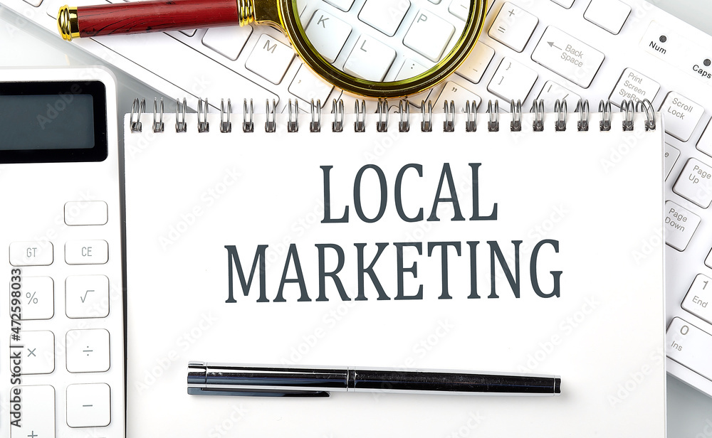 Poster local marketing . text on notepad with calculator and keyboard,business concept