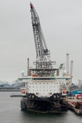 Fototapeta premium Port of Rotterdam, the Netherlands - 09 23 2020: Crane vessel Seaway Strashnov during the test of loading equipment in the port.