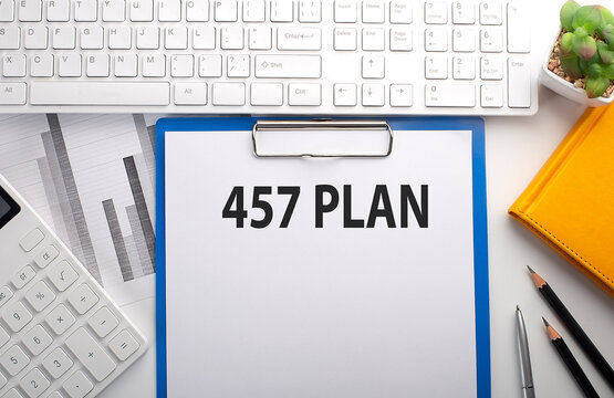 457 PLAN written on the paper with keyboard, chart, calculator and notebook