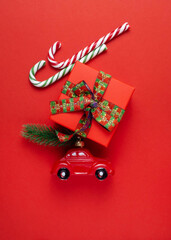 Car, gift, lollipop, candy on a red background.