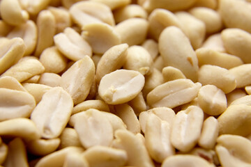 Raw blanched peanuts as food background