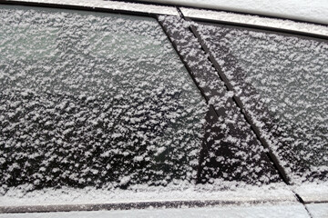 Snow on car window.