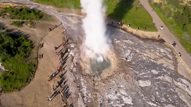 Aerial Cinematic footage of the Impressive Icelands Geysir Geisir in the Golden Circule, the geothermal activity and a attraction for tourists in Iceland	