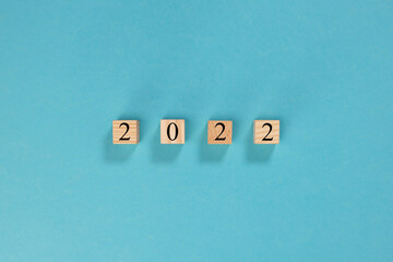 2022 year on wooden blocks on light blue background	