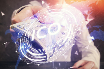 Multi exposure of blockchain theme drawing hologram and USA dollars bills and man hands. Business...