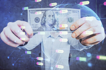 Double exposure of technology drawing hologram and us dollars bills and man hands. Data concept