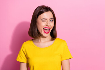 Photo of brunette impressed young lady blink wear vivid t-shirt isolated on pastel pink color...