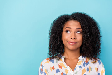 Photo of unsure millennial wavy hairdo lady look empty space wear white shirt isolated on blue...
