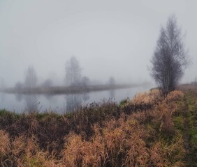 Autumn river in the morning in thick fog