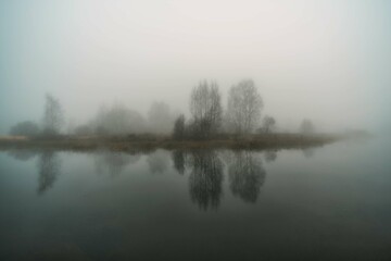 Fototapeta premium Autumn river in the morning in thick fog