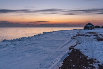 Snow, ice and sun on the shore of the winter north sea