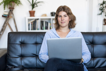 young beautiful woman using a laptop computer at home