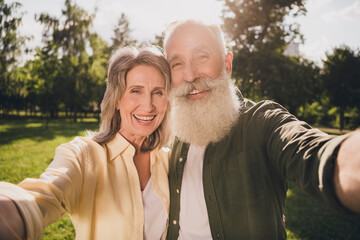 Photo of wife husband happy old man woman make selfie smile weekend walk outdoors outside park in city forest