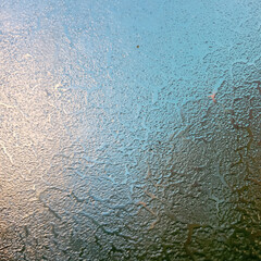 Frost on the windshield, the rays of the morning sun melt the frost formed overnight. Background,...