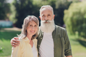 Photo of nice expression old grey hair couple hug wear shirts outdoors weekend in park