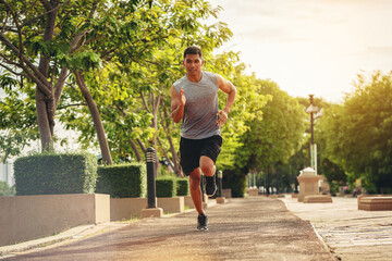Silhouette of young man running sprinting on road. Fit runner fitness runner during outdoor workout...