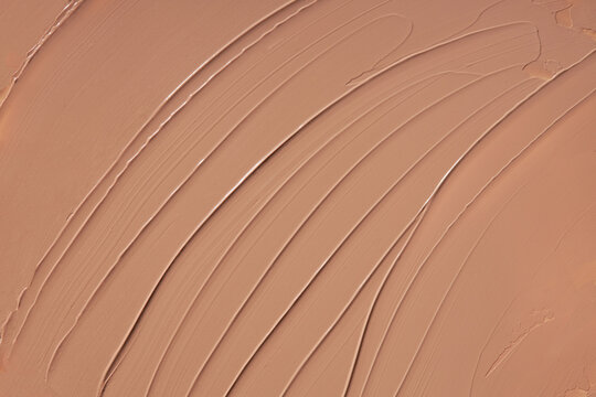 Liquid foundation texture background, beige concealer paint smears