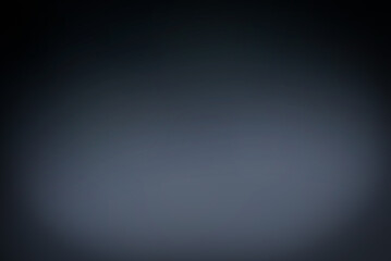 Abstract background, wall of black paper is blurry with some bright grayish white light.for graphic design ,spacefor text