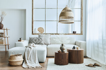 Stylish interior of living room with design modular sofa, furniture, wooden coffee table, rattan...