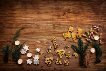Homemade cookies on old wood. Background for sweet christmas and advent baking. Top view with space for your text.
