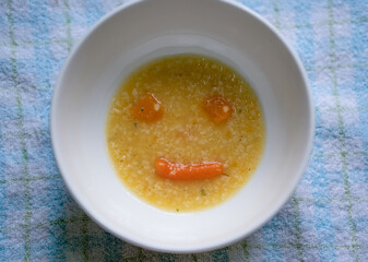 Carrot and pumpkin soup in the form of a smile. Positive attitude and delicious healthy food. Soup for the baby smiles