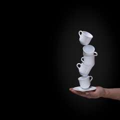 cups balancing construction on a black background