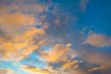 Naklejka na ściany i meble Clouds in a blue sky in bright sunlight at sunrise in autumn, Almere, Flevoland, The Netherlands, November 29, 2021 