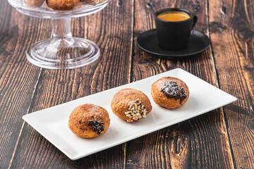 Bombolone or bomboloni is an Italian filled donut and snack food. German donuts - krapfen or berliner - filled with jam and chocolate