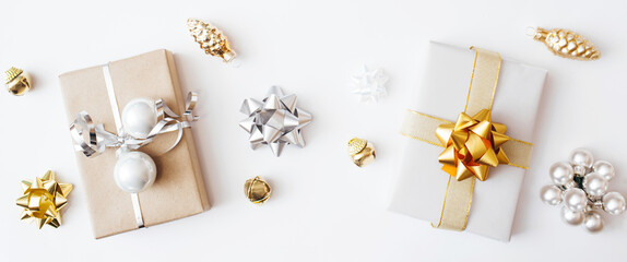Fototapeta na wymiar Banner made of Christmas presents and gifts and gold and silver decorations on white background. Merry christmas, New Year holiday concept. Flat lay, top view