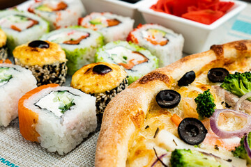 A beautiful set of sushi with pizza. 