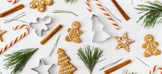 Christmas Banner. winter, new year composition. Christmas frame made of cinnamon sticks, candies, gingerbread on white background. Flat lay, top view, copy space