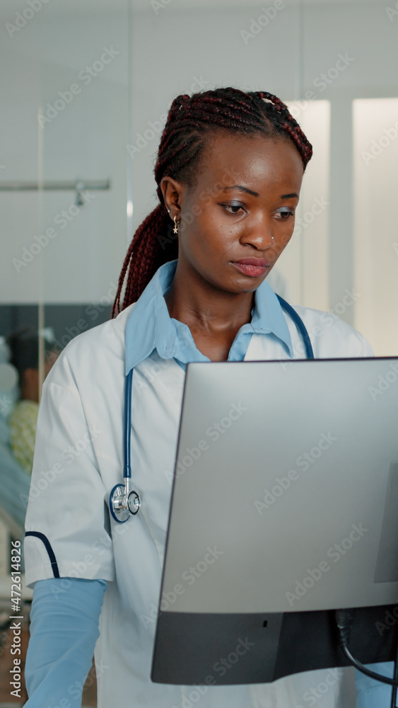 Aufkleber woman working as doctor with stethoscope using computer to find patient documents for information in