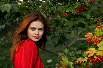 pretty woman in the summer outdoors near the bush